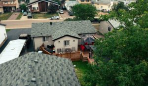 A charming house showcasing a well-defined roof and an inviting patio space for outdoor enjoyment